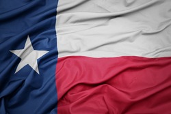 waving colorful flag of texas state. macro shot