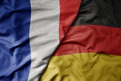 big waving realistic national colorful flag of france and national flag of germany . macro