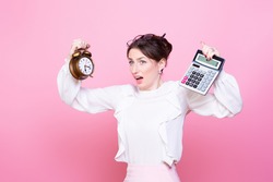 Young woman with a clock and a calculator in her hands panics from rush and lack of time. How to do everything. The problem of time management