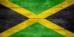 flag of Jamaica or  Jamaican banner on wooden background