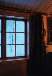  cabin window with view on a snow covered landscape