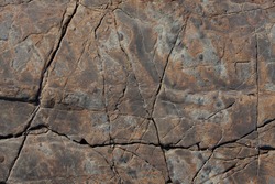 Brown stone with cracks on the surface
