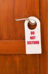 A do not disturb tag at the front of the hotel room