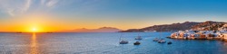 Sunset panorama of Mykonos island, Greece with yachts in the harbor and colorful waterfront houses of Little Venice romantic spot on sunset with cruise ship and yacht boats. Mykonos townd, Greece