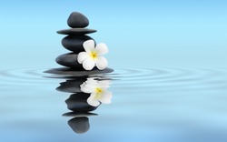 Zen spa concept panoramic banner image - Zen massage stones with frangipani plumeria flower in water reflection