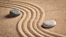 Japanese Zen stone garden - relaxation, meditation, simplicity and balance concept  - panorama of pebbles and raked sand tranquil calm scene