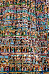 Hindu temple gopura (tower) with statues of deities close up. Menakshi Temple, Madurai, Tamil Nadu, India