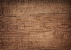 Dark brown scratched wooden cutting board. Wood texture