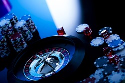 high contrast image of casino roulette, playing chips and dice