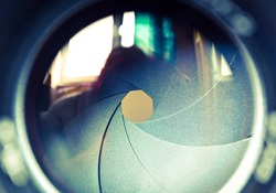  The diaphragm of a camera lens aperture. Selective focus with shallow depth of field. Color toned image.