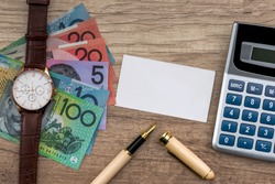 Australian dollar with business card, pen and calculator