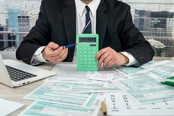 man wear suit filling tax form, business concept