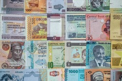 close-up of African currency of various colors shapes and denominations filled the entire table. trade. banknotes of different denominations. Africa