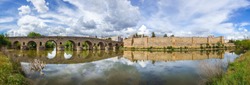 View of the Roman bridge of Merida with its reflection on the Guadiana river. Merida. Spain.The Archaeological Ensemble of Merida is declared a UNESCO World Heritage Site Ref 664. Panorama image from