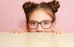 Cute little girl child preteen in eyeglasses isolated. Education, school and vision concept 