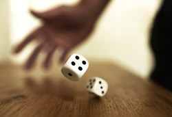 rolling dices on a wooden table