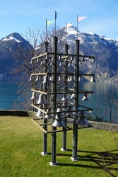 Tellsplatte Glockenspiel bells on the banks of Lake Lucern with Swiss alpine snow capped mountains in the background