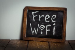 Free wifi sign. Wooden table.