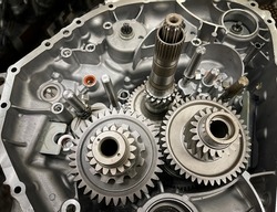 gearbox of an open engine with sprockets, shafts, gearwheels, transmission of a combustion engine, car parts, mechanics, automotive industry