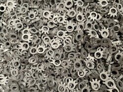 batch of metallic steel parts, mass production of toothed sprockets, lots of steel parts, fine blanking of gear wheels, manufacture of car parts, cold stamping of components, iron pieces