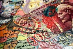 Close up of a 5 US dollar bill and Russian ruble banknote on top of a map of Ukraine