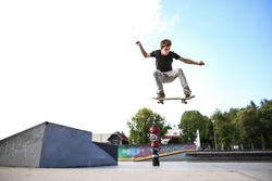 Skateboarder doing ollie from the kicker
