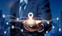 Businessman use internet network on mobile phone find location in the city by GPS Navigator Map. Man hold smart Phone connect to GPS location icon show global business, direction, travel, 5G concept.