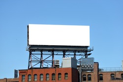 Outdor advertising in the city, mockup. Large billboard on roof top of brick building. 
