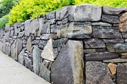 Retaining Wall Detail. Closeup of dry stone wall built with natural flagstones and wallstones of irregular shapes and sizes