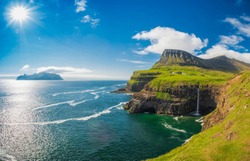 Gasadalur village and Beautiful  waterfall, Sunny Day, Vagar, Faroe Islands, Denmark. 