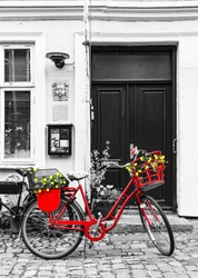 Retro vintage red bicycle on cobblestone street in the old town. Black And White Toned. Ribbe, Denmark