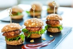 Close up of mini hamburgers at catering event.