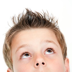 Extreme close up portrait of boy looking up.Isolated on white.