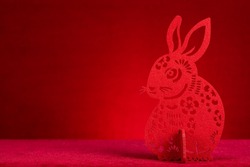 Chinese New Year of Rabbit mascot paper cut on red with copy space at horizontal composition no logo no trademark