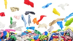 Separate clothing falling at the big pile of clothes on a white background