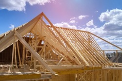 Timber frame house of gables roof on stick built home under construction new build roof with wooden beam framework