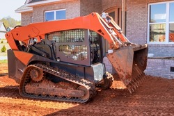 Mini bulldozer working with earth, moving soil doing landscaping works the territory improvement