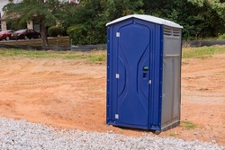 Workers using the portable restroom on a construction site