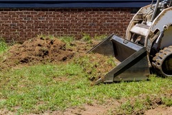An earth moving is landscaping work in order to move earth using bulldozer scoop