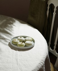mochi with pistachio ice crem, japanese traditional food on the white tablecloth, harsh light