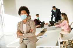 African American woman in the office wear mask as protection from corona virus