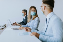 Group of business people have a meeting and working in the office and wear protective facial masks as protection from corona virus