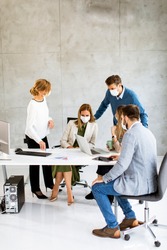 Group of business people have a meeting and working in the office and wear masks as protection from corona virus