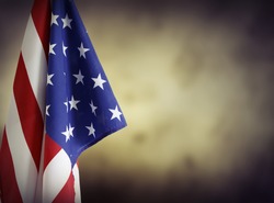 American flag in front of plain background. Advertising space