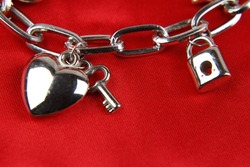 Closeup of heart and key on charm bracelet