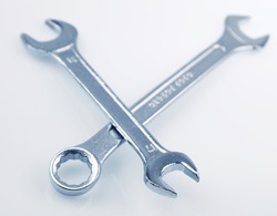 Two metal spanners on plain background