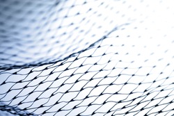 Closeup of abstract fishnet on white background. Blue tone