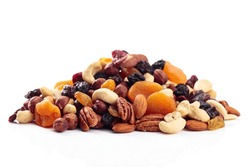 Mix of nuts and dried fruits isolated on a white background. Presented apricots, raisins, walnuts, hazelnuts, cashews, pecans, and almonds.