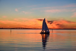 Sailing at sunset in front of the Oland bridge in the Baltic sea, Sweden