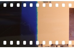 Strip of the poorly exposed and developed celluloid film on white background